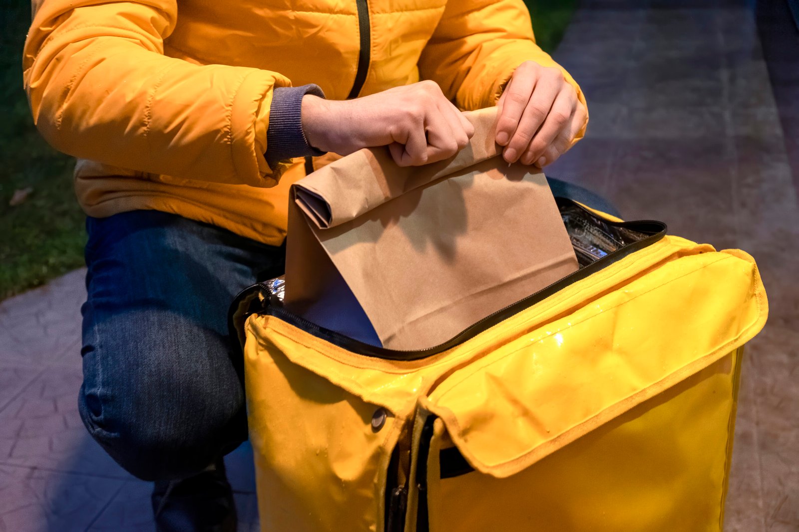 Food Delivery Man pulling out bag from Yellow insulated bag